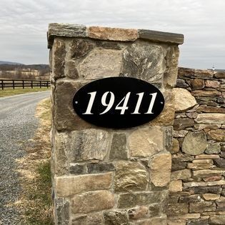 A stone wall with a sign that says 19411 on it