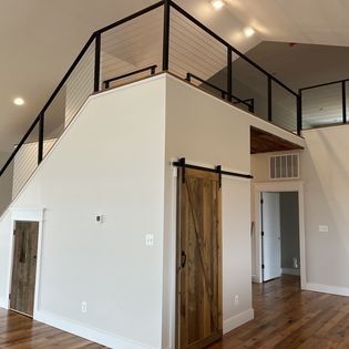 There is a sliding barn door in the middle of the room.
