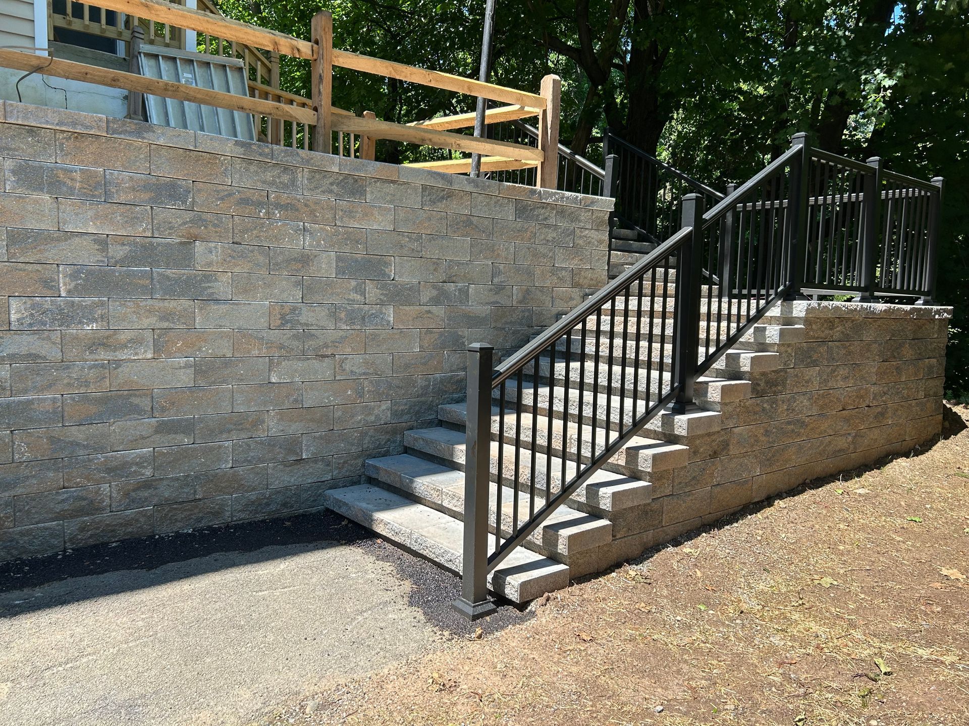Brick steps leading up to a walkway, with brick retaining walls on either side.