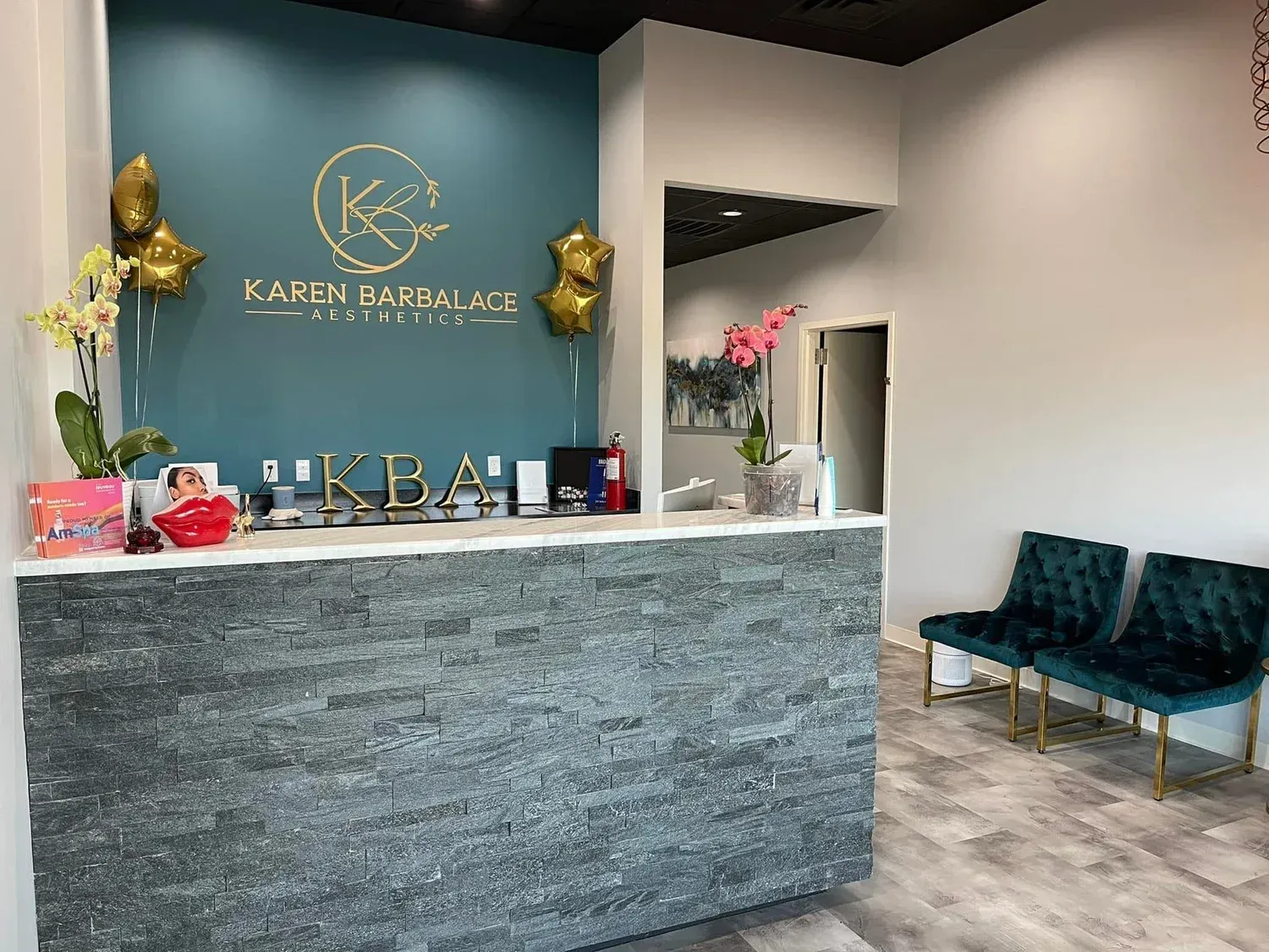 Reception desk in teal and gray spa setting with name