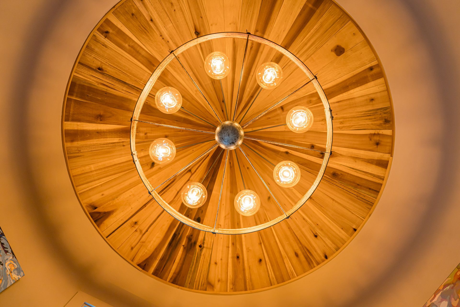 Ornate wooden ceiling with a circular chandelier and warm amber lighting