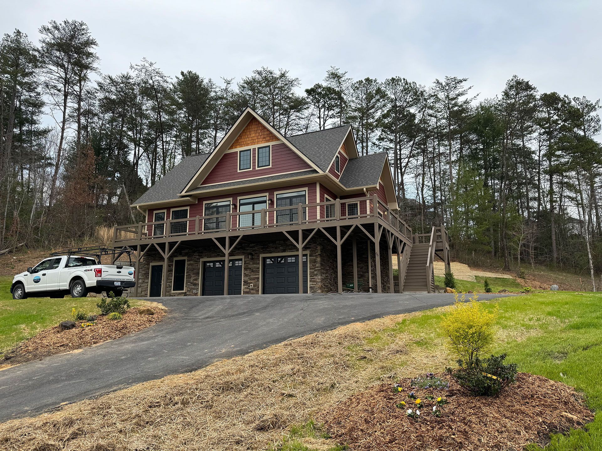 A large house with a white truck parked in front of it.