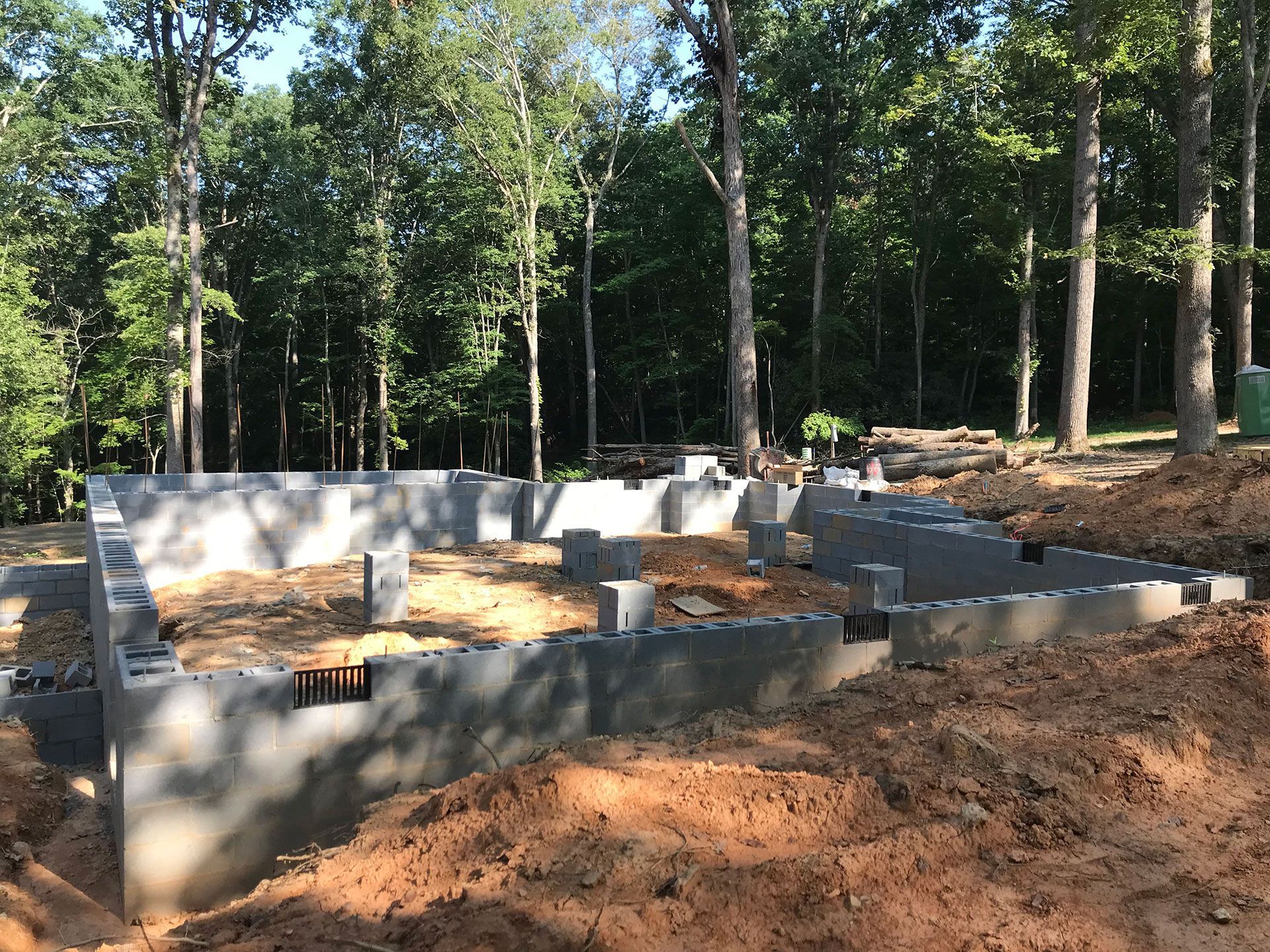 A concrete foundation is being built in the middle of a forest.