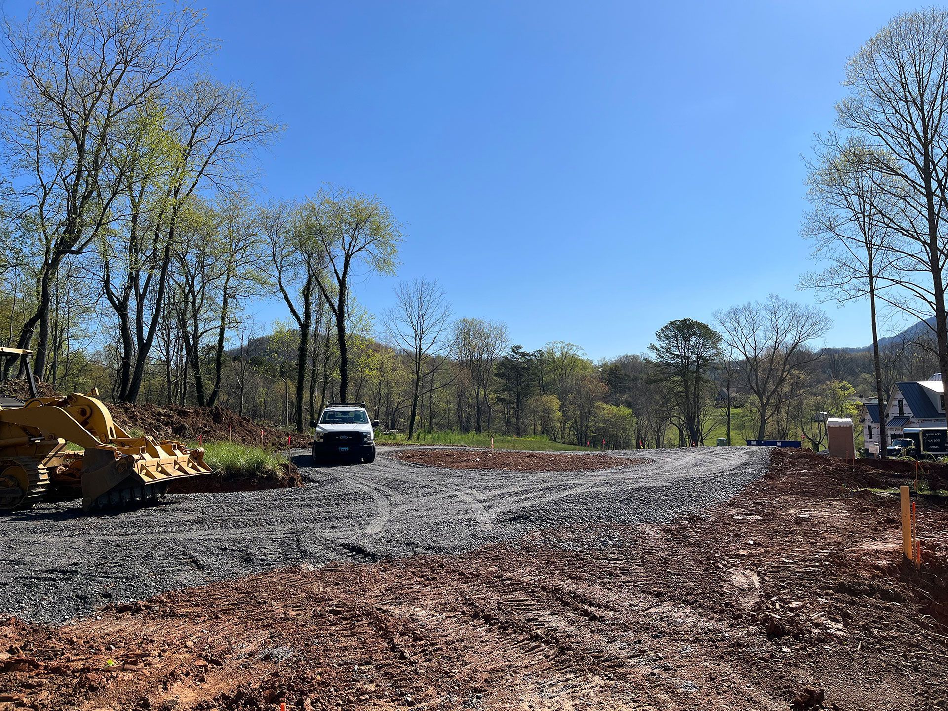 A bulldozer is sitting in the middle of a dirt road.