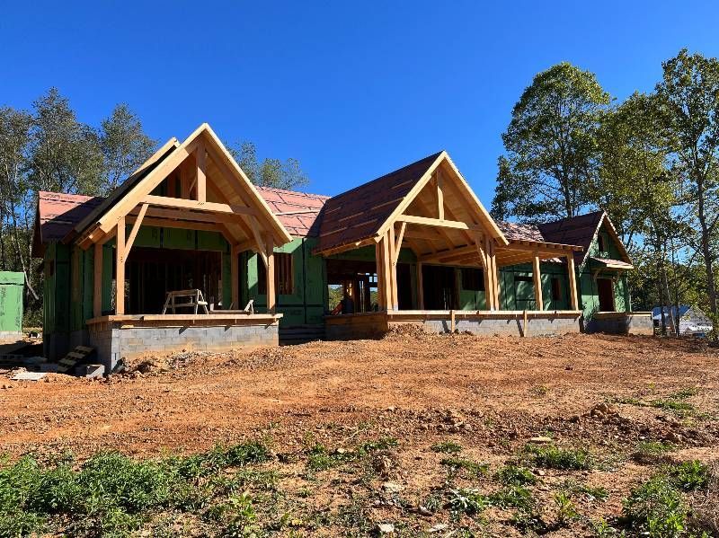 A house is being built in the middle of a dirt field.