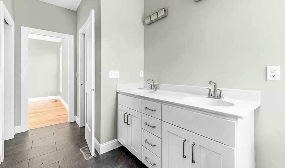 A bathroom with two sinks and a mirror.