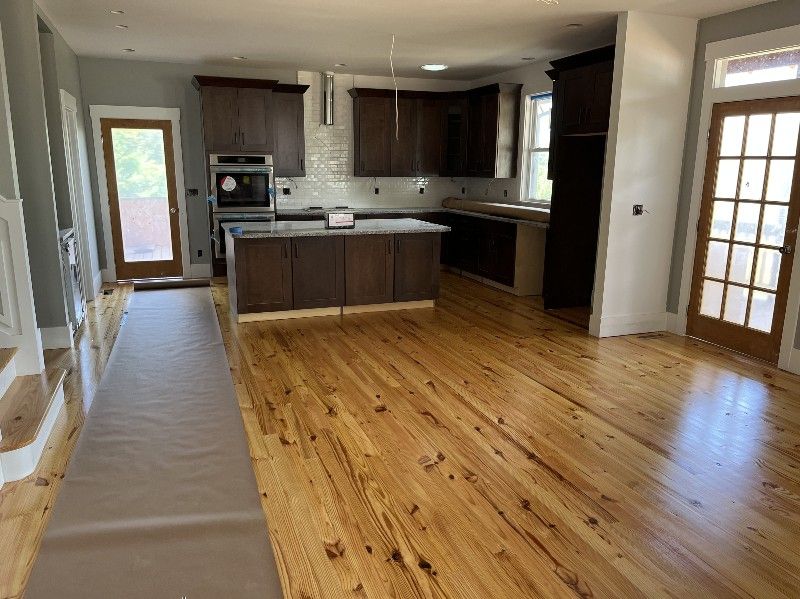 A kitchen with wooden floors and a large island