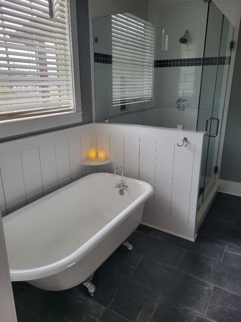 A bathroom with a bathtub and a shower.