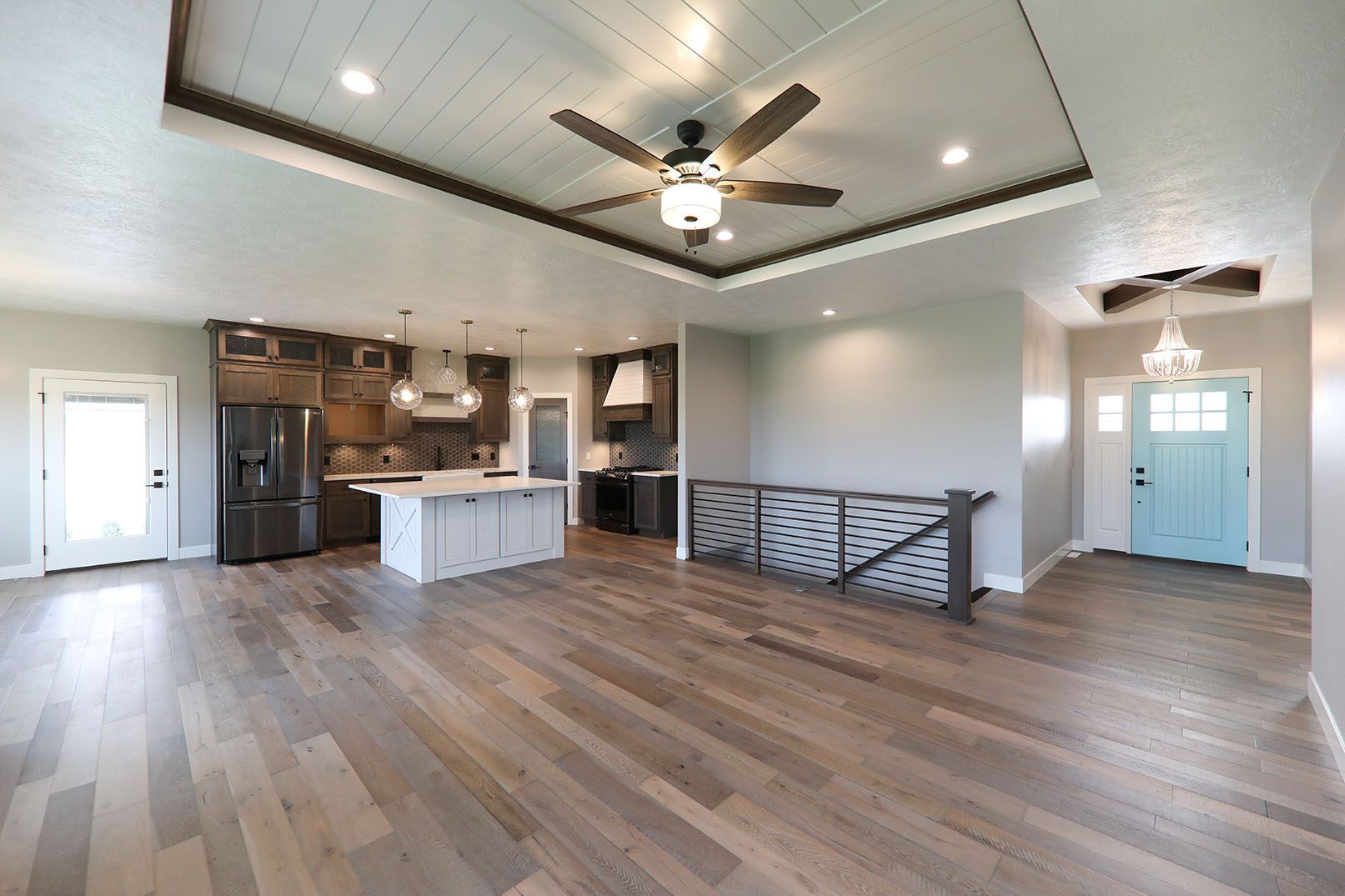 A living room with hardwood floors and a ceiling fan.