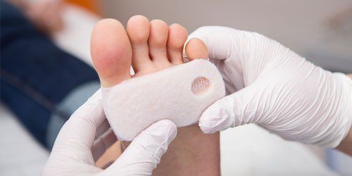 Podiatrist cleaning woman’s feet