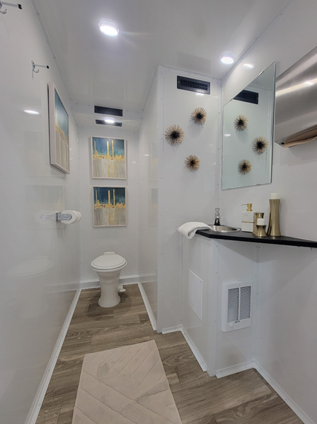 A bathroom with a toilet a sink and a mirror