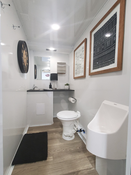 A bathroom with a toilet, urinal and sink.