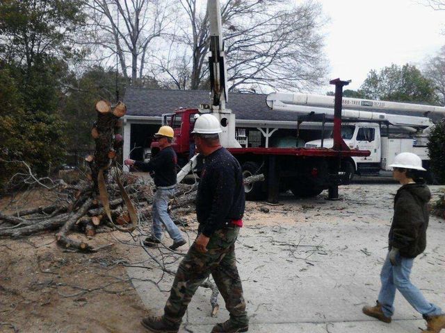 A group of people wearing hard hats are walking in front of a truck