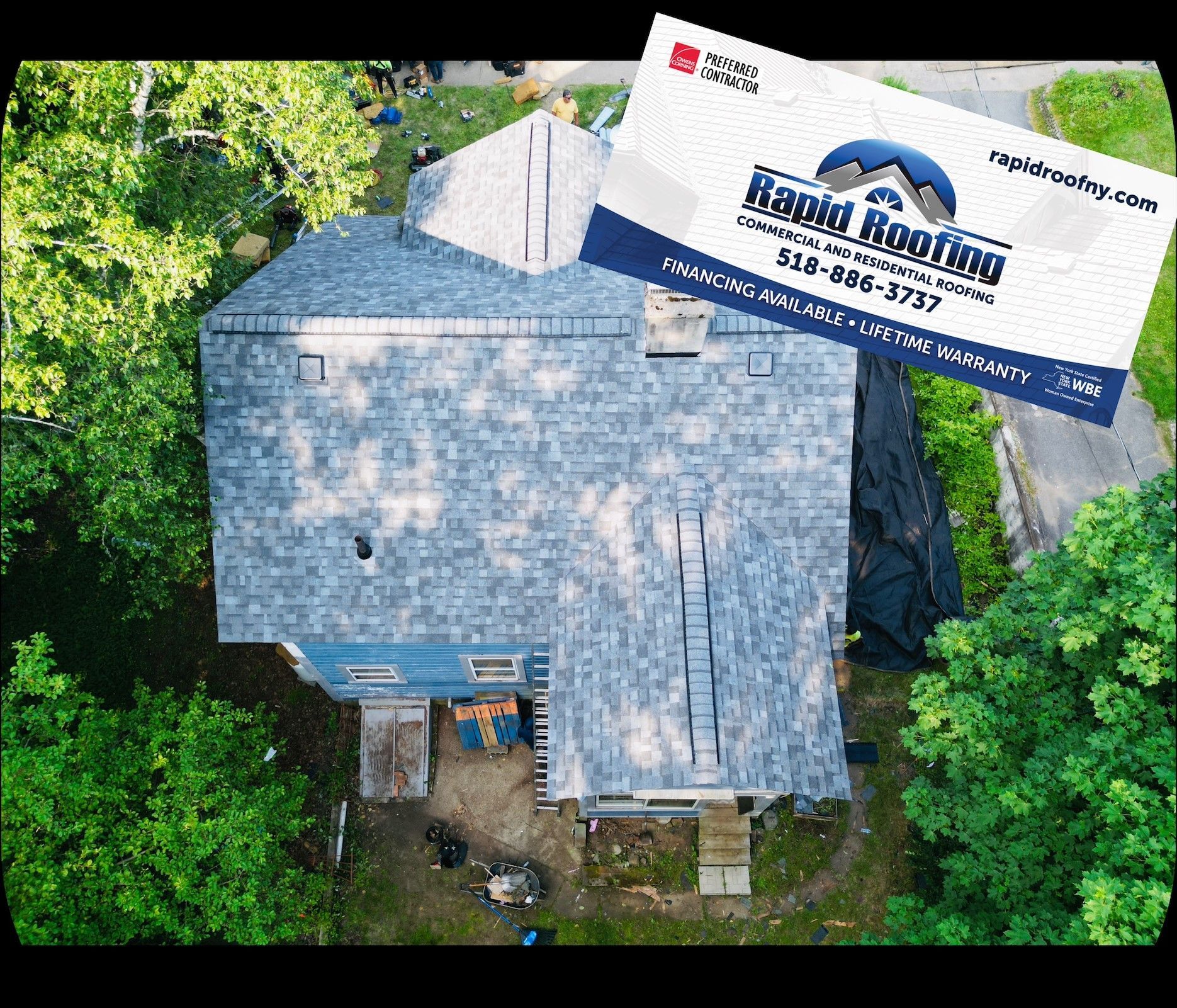 An aerial view of a house with a business card on top of it.
