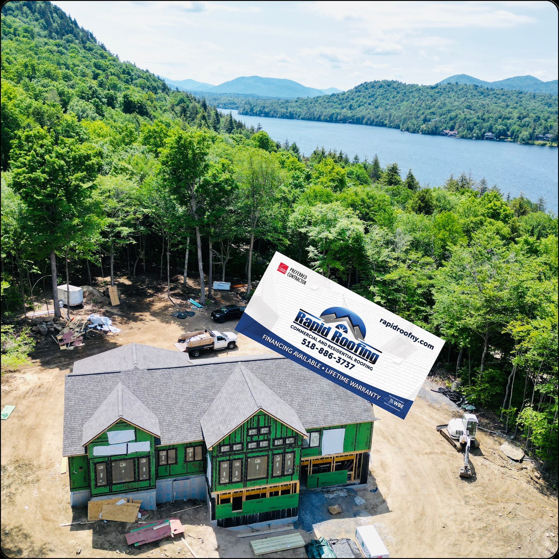 An aerial view of a house under construction with a business card above it.