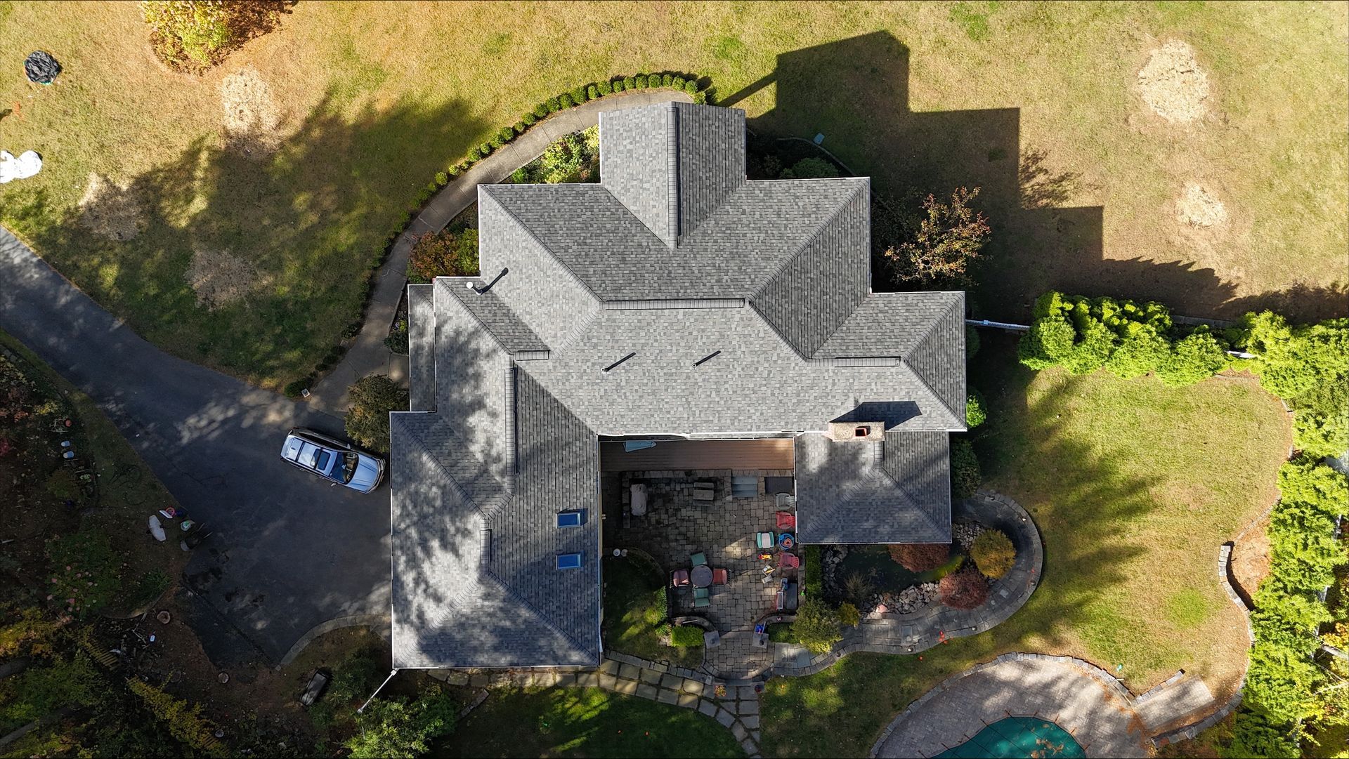 An aerial view of a house with a car parked in front of it.