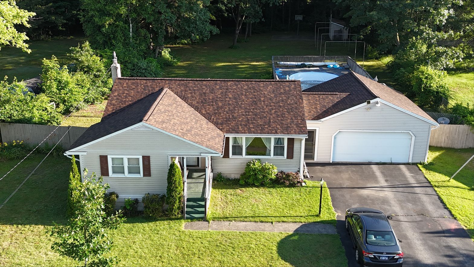 An aerial view of a house with a car parked in front of it.