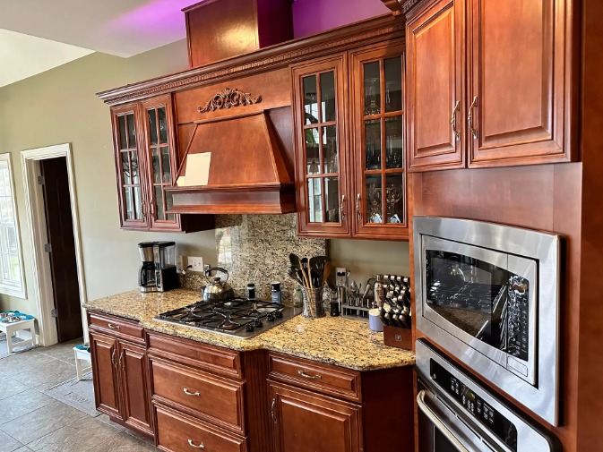Kitchen with brown cabinets, granite countertops, stainless steel appliances, and a gas cooktop.