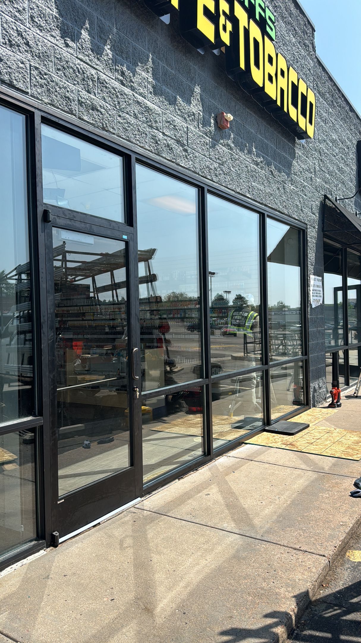 Storefront with glass windows and a black frame, displaying 