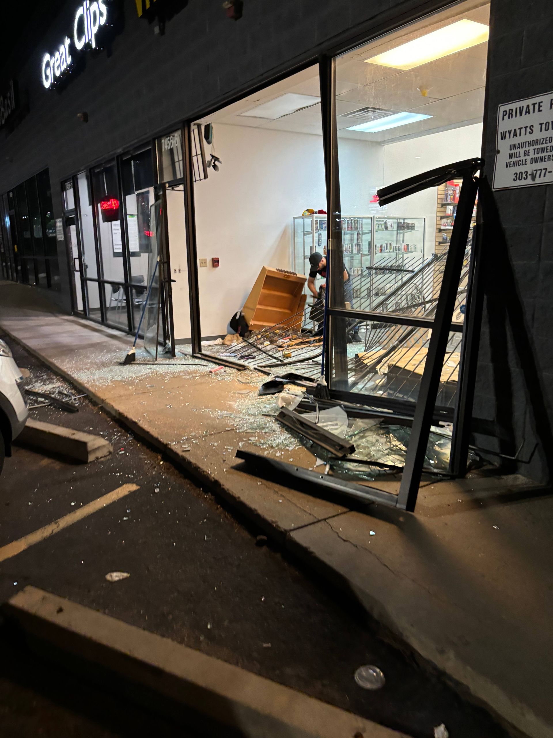 A shattered storefront with broken glass and debris.