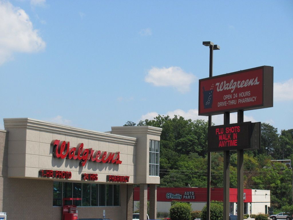 Walgreens store with red signage, open 24 hours. A sign below says 