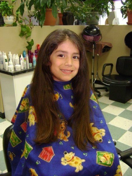 a little girl wearing a blue cape
