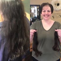 a woman is holding a bunch of hair in her hands and smiling.