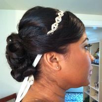 a woman is wearing a headband and a bun.