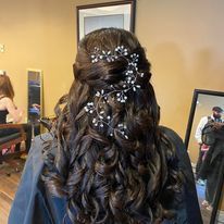 a woman is getting her hair done in a salon.