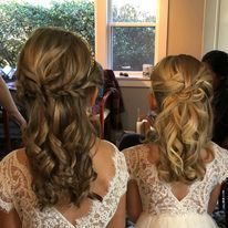 two flower girls are sitting next to each other with their hair in a half up half down hairstyle.