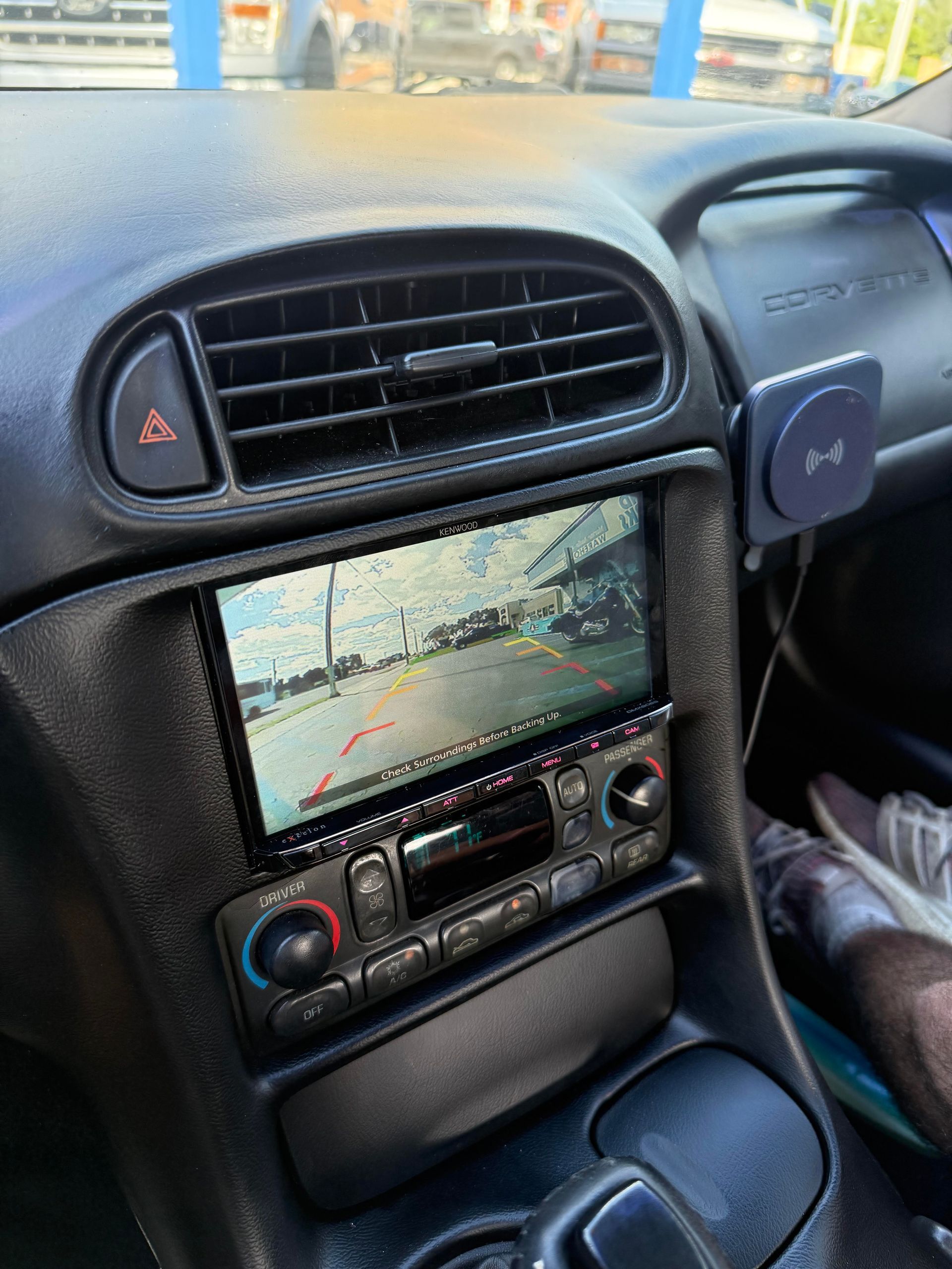 Car interior showing a backup camera display in the center console of a Corvette.