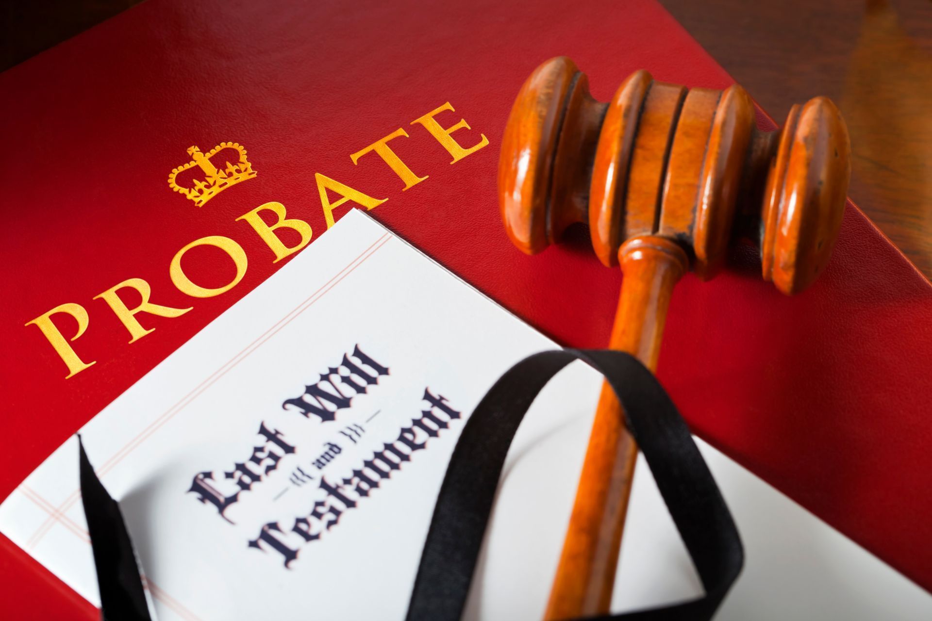 A wooden gavel is sitting on top of a red book that says 