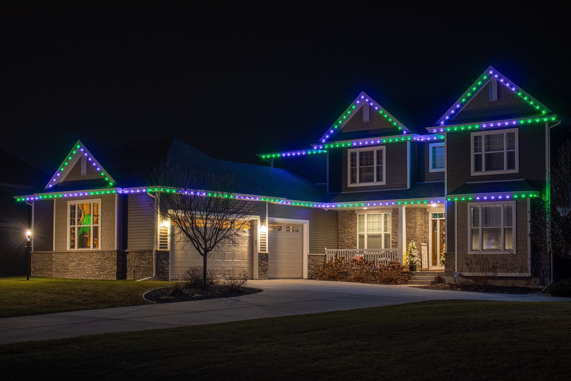 House decorated with colorful Christmas lights at night