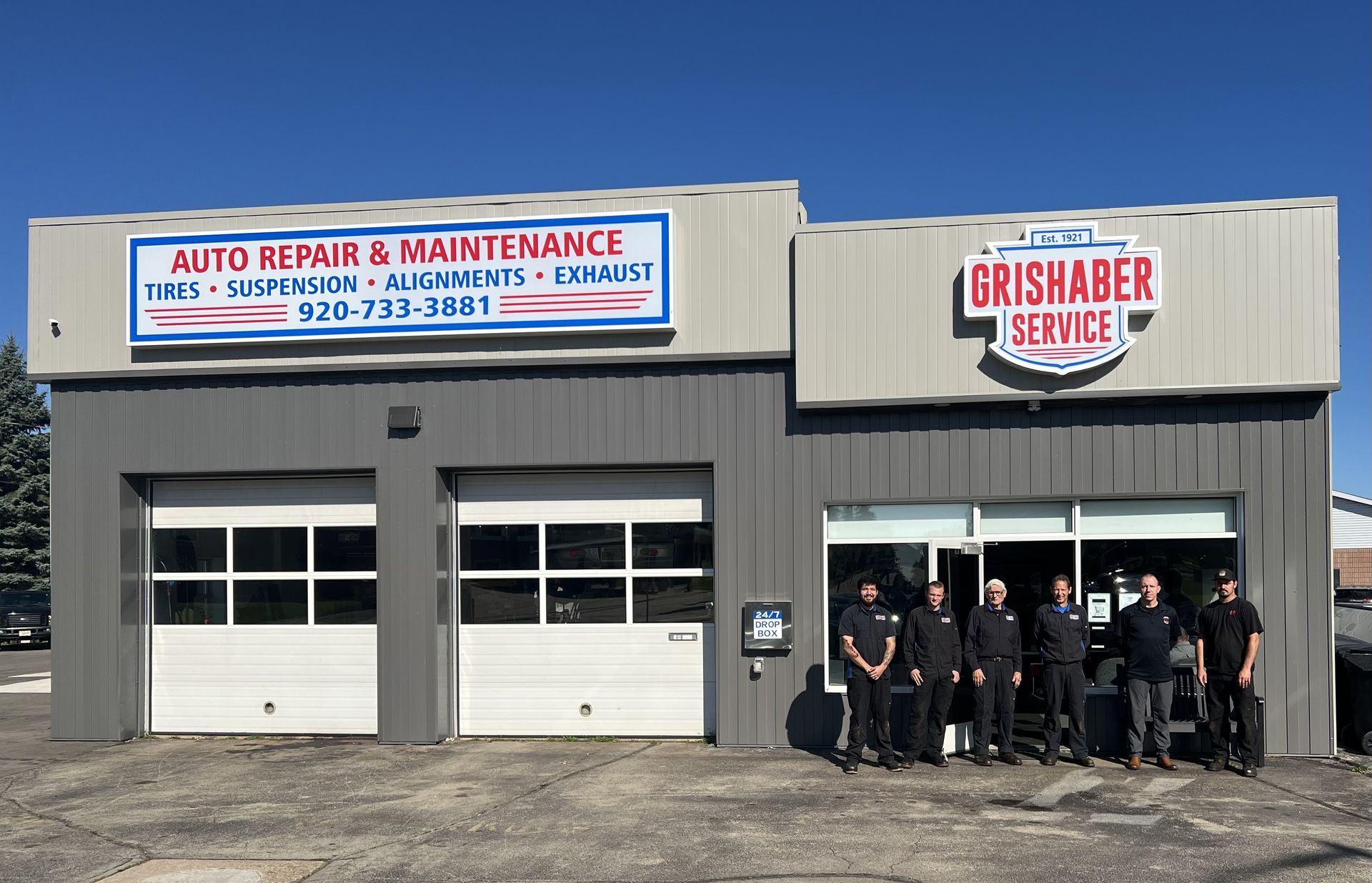 Grishaber Service auto repair shop with a team of technicians posing in front.
