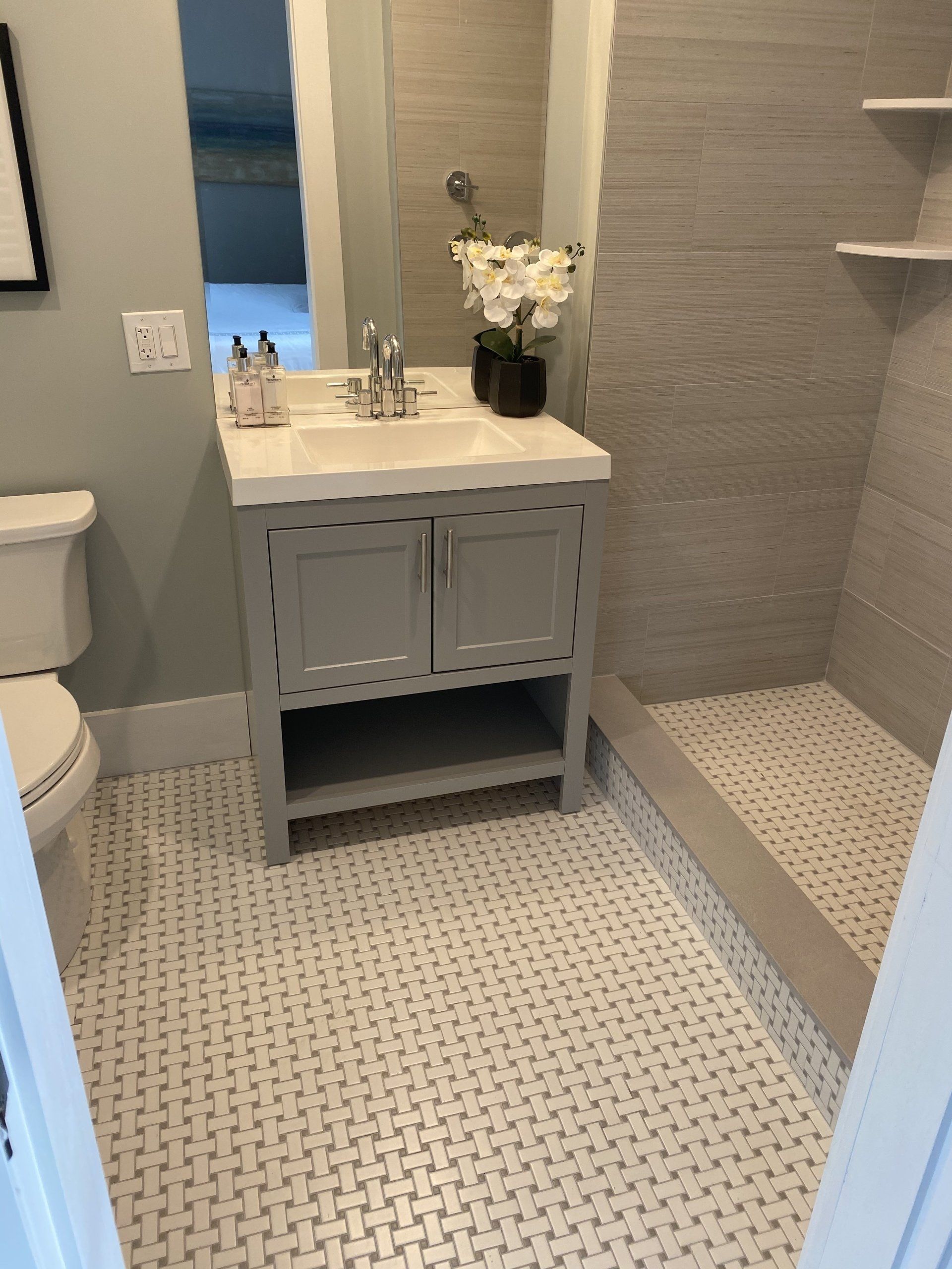 a bathroom with a sink, toilet and shower