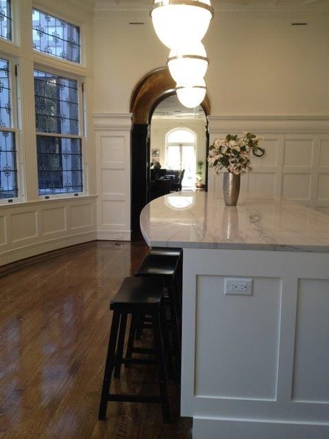 a kitchen with a large island and stools