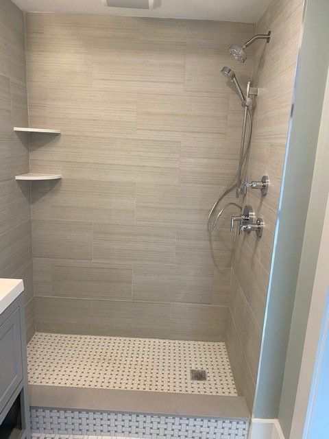 a bathroom with a walk in shower and a sink