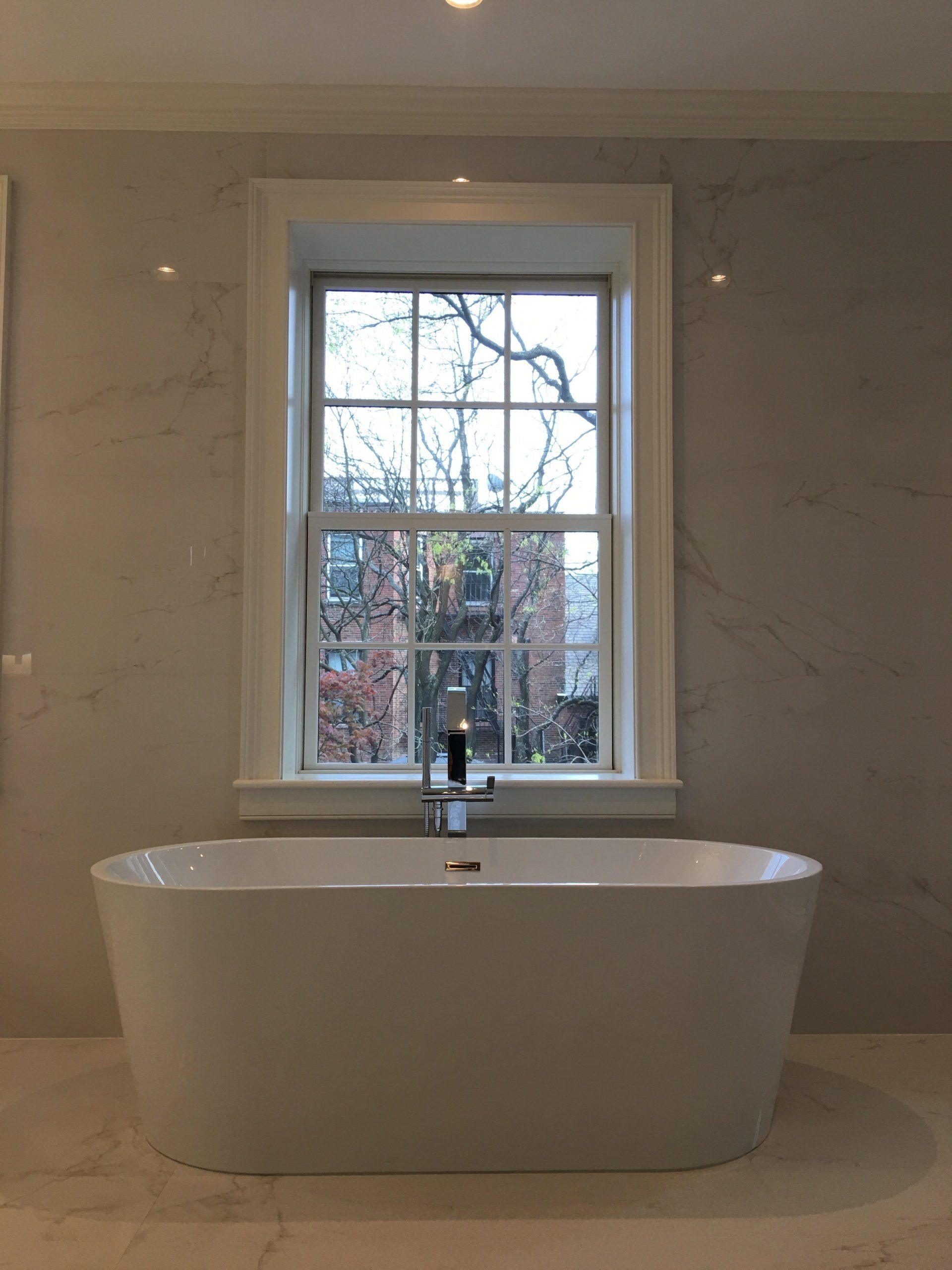 a bathtub in a bathroom next to a window