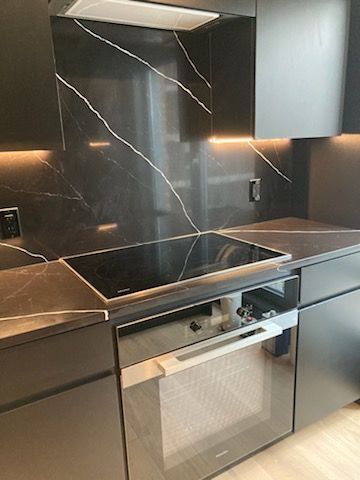 A kitchen with stainless steel appliances and a stove top oven.