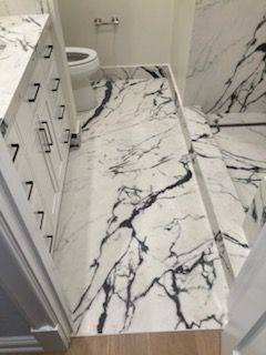 A bathroom with a black and white marble floor