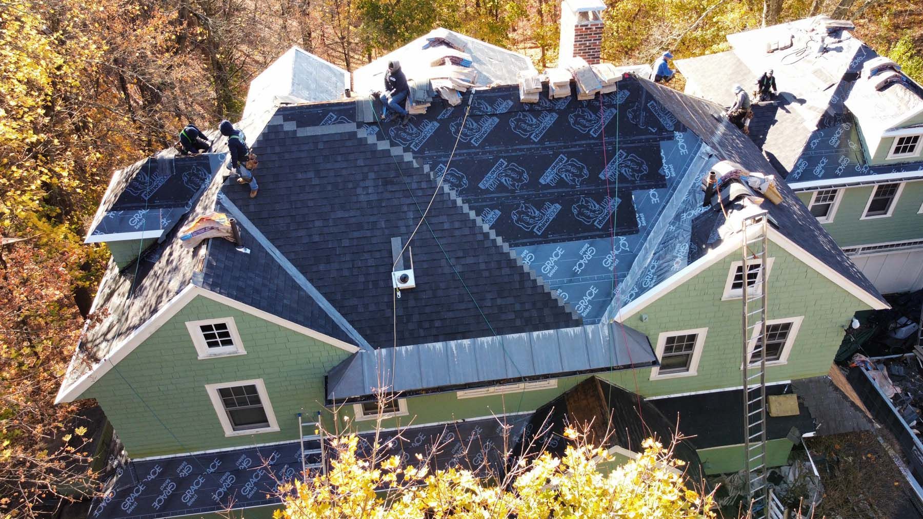 An aerial view of a house with a roof being installed.
