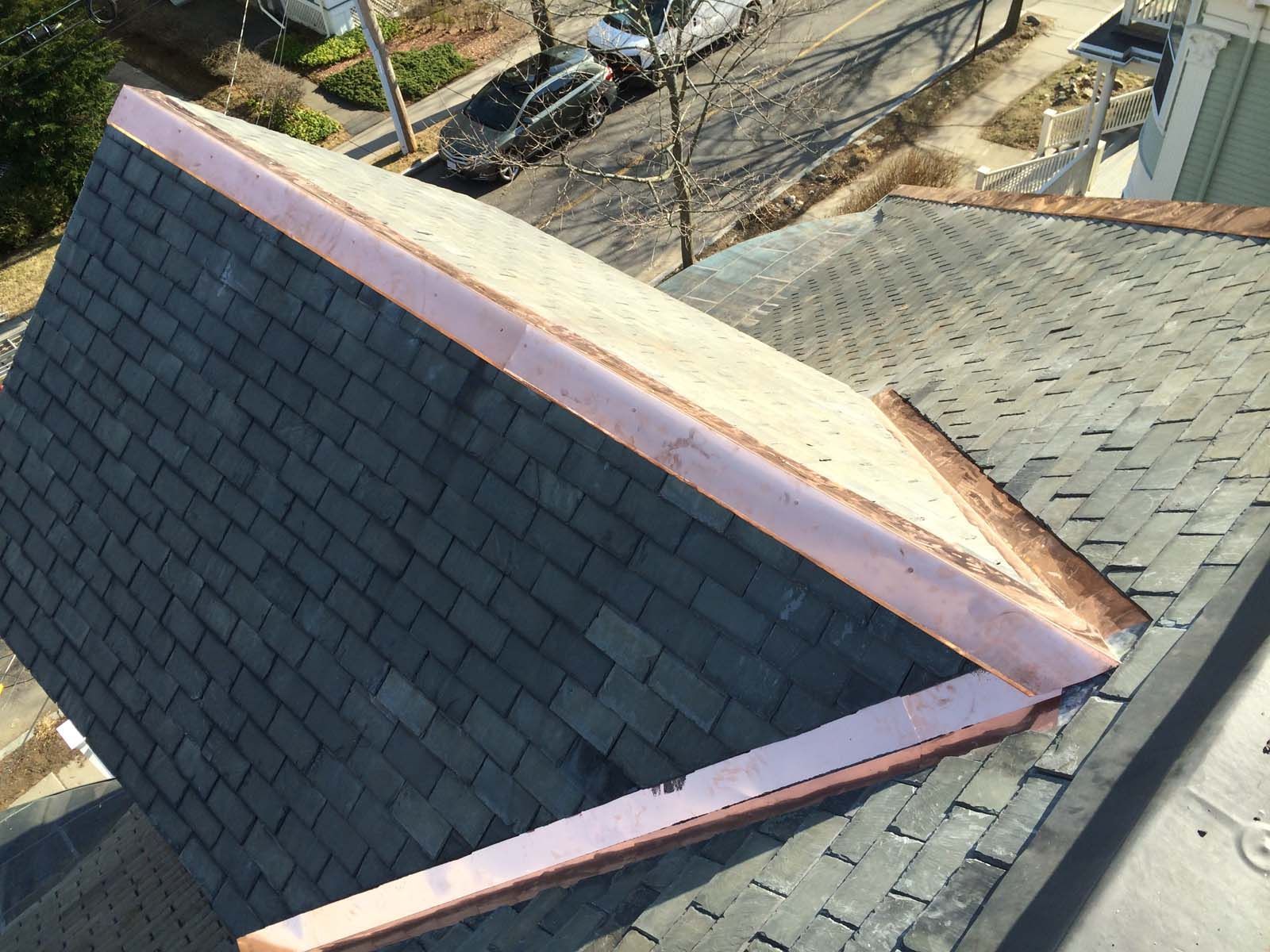 An aerial view of a roof with a copper trim.