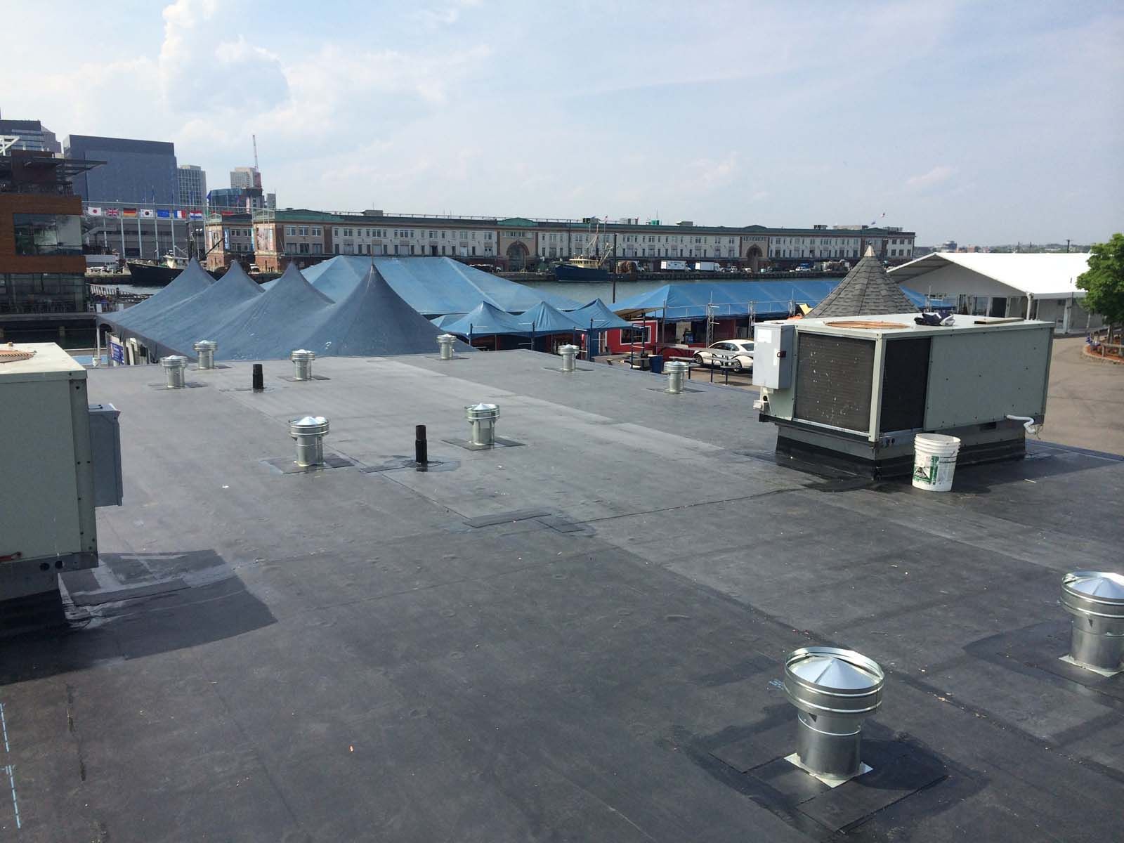 The roof of a building has a lot of air vents on it