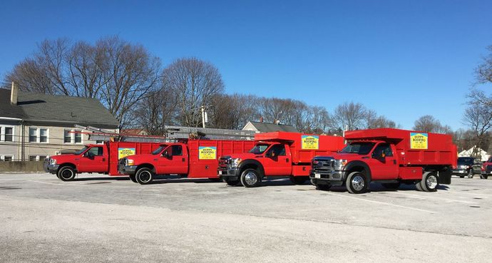 A row of red trucks parked in a parking lot