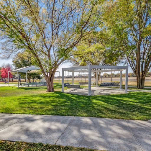 sidewalk and trees with white gazebos