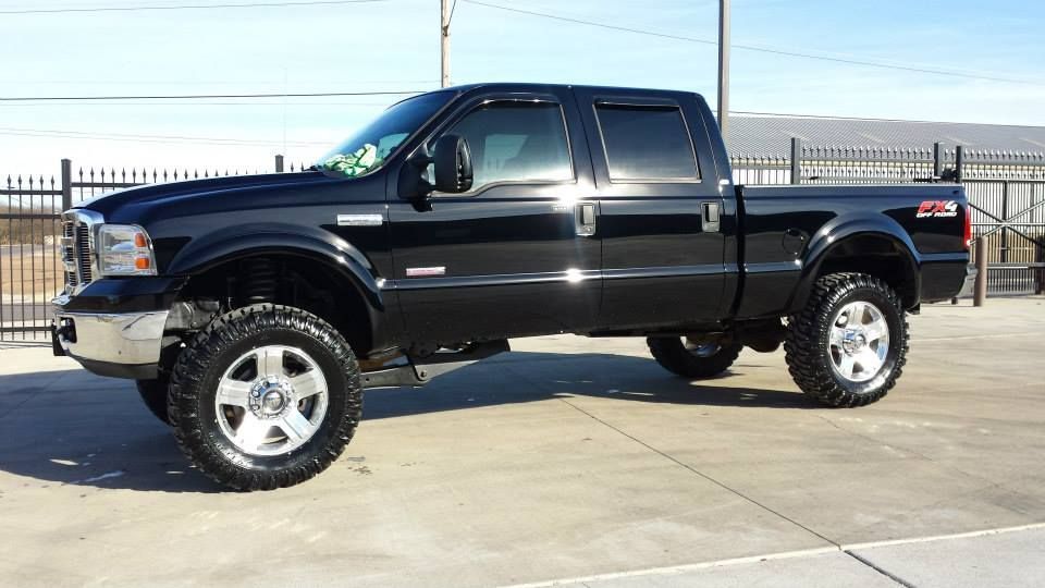 A black pickup truck is parked in a parking lot.