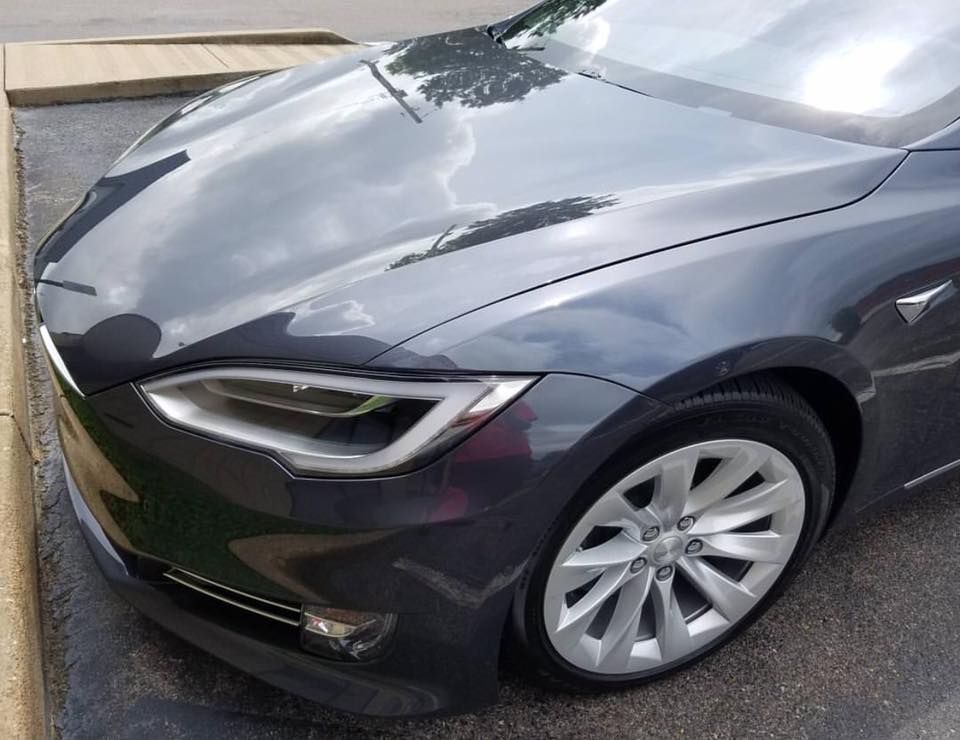 A tesla model s is parked in a parking lot.