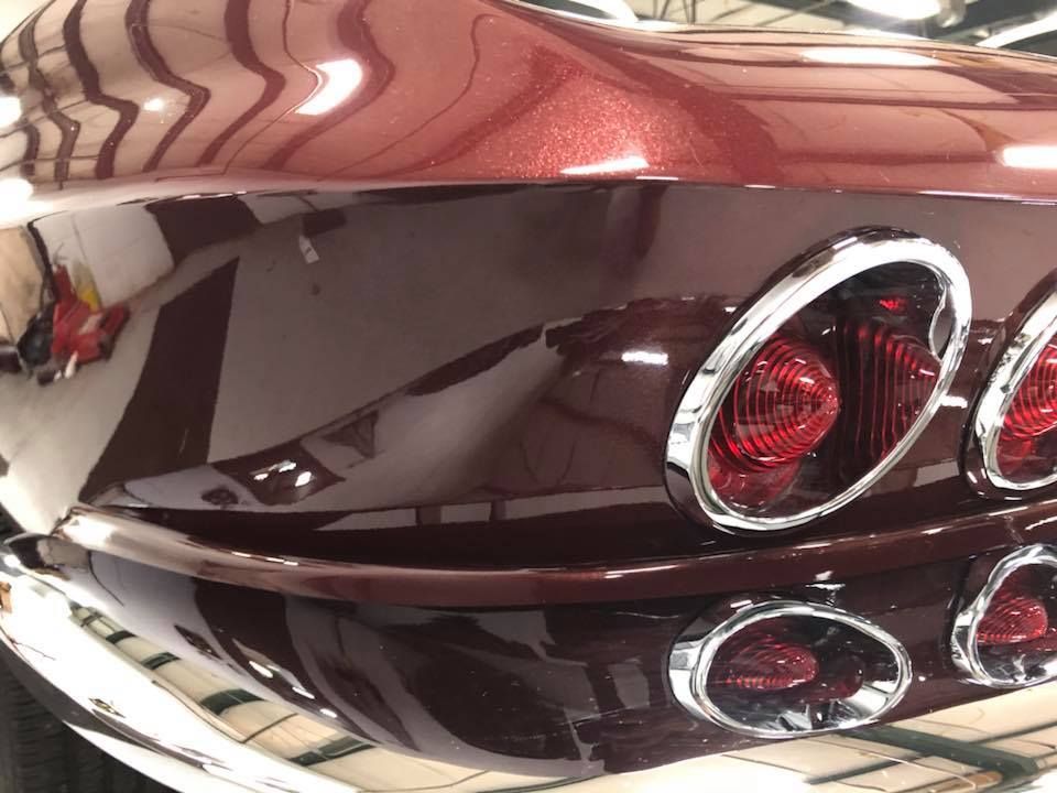 A close up of the rear end of a red car.