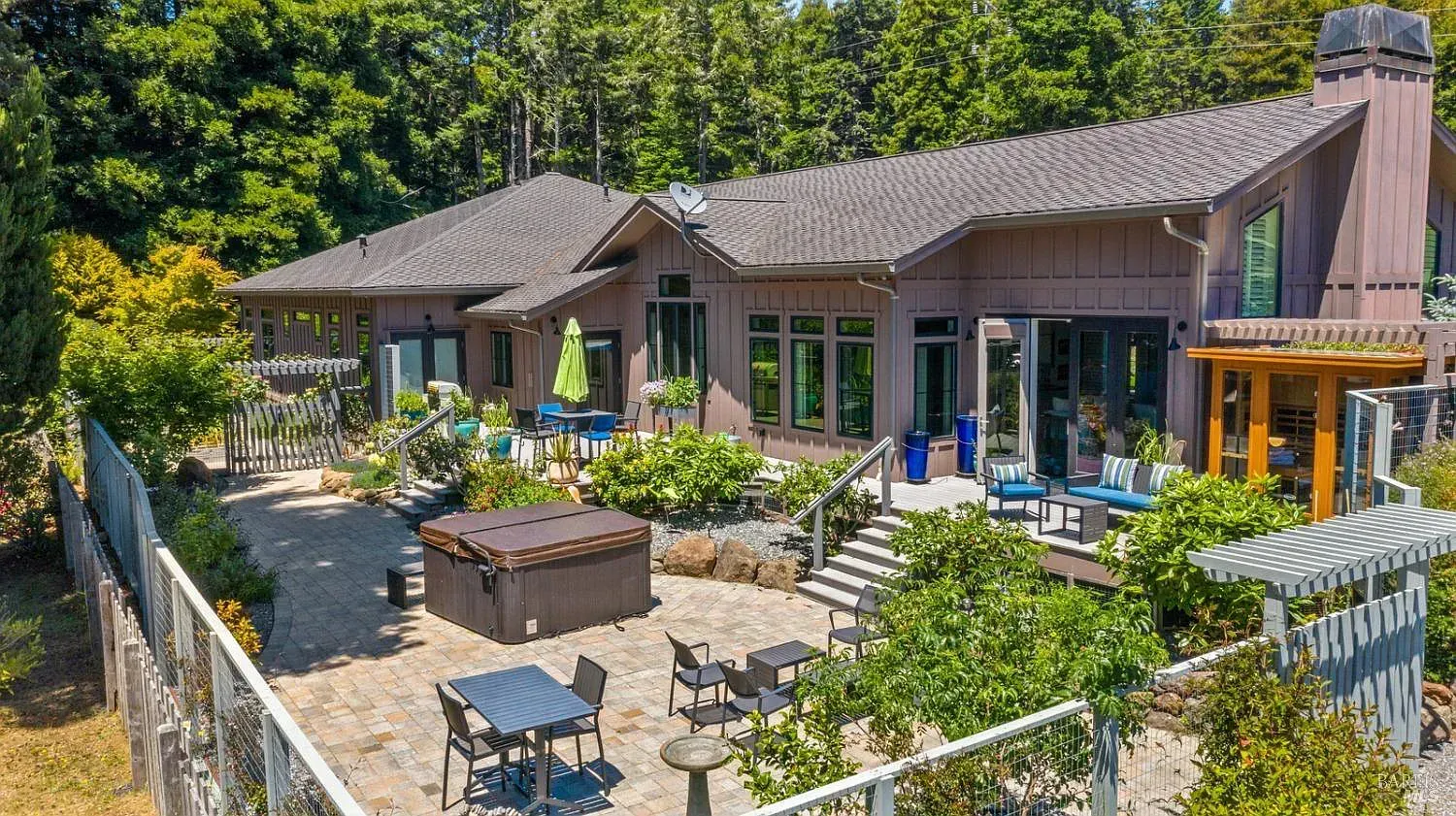 an aerial view of a large house with a hot tub in the backyard
