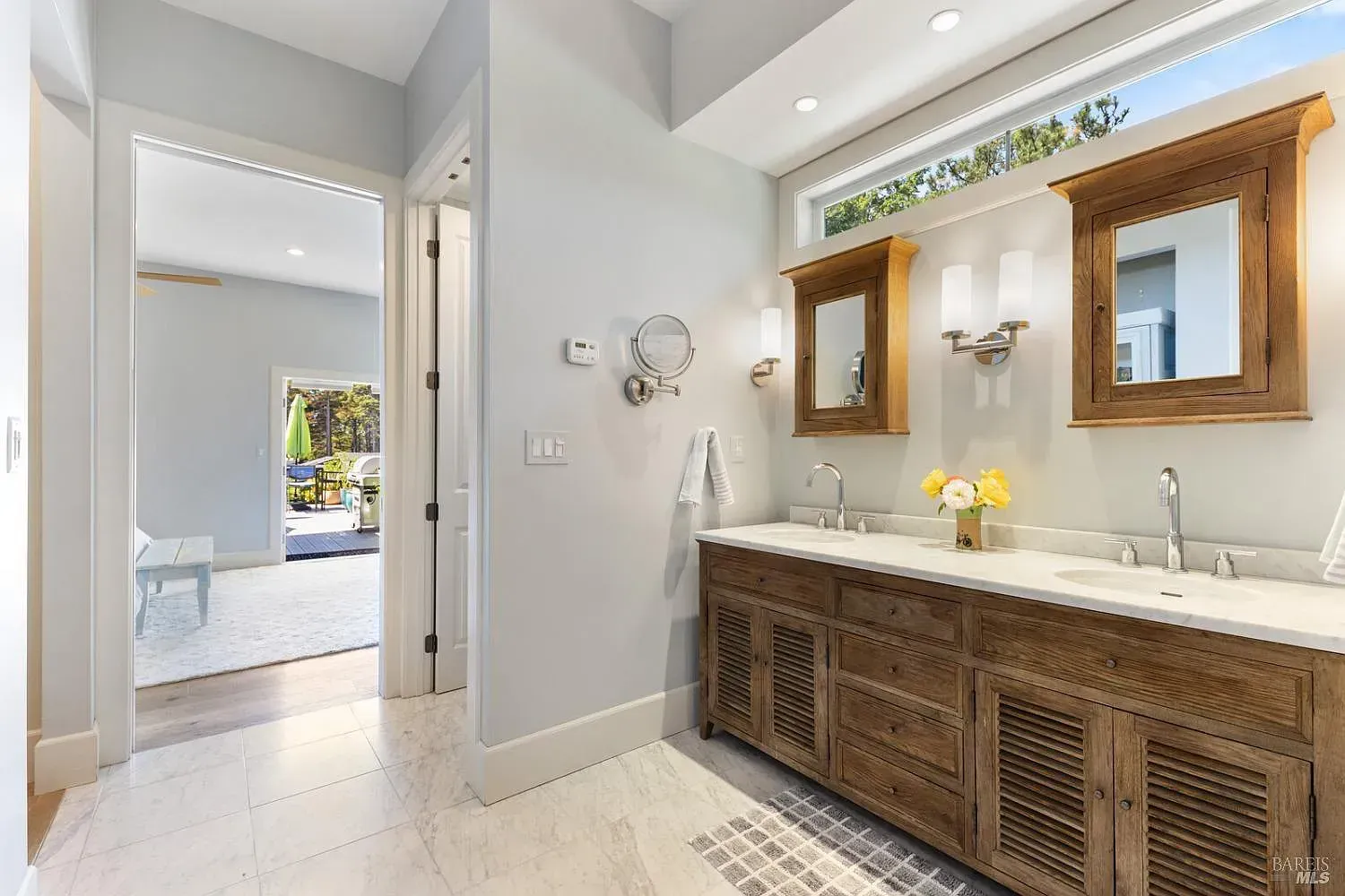 a bathroom with two sinks and two mirrors